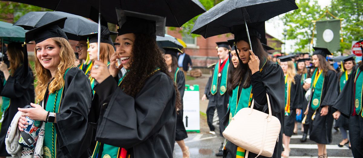 Students march through the rain on commencement day.