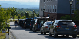 cars lines up along the road near university place