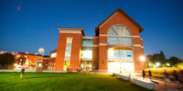 Exterior shot of the davis center from the green roof at dusk