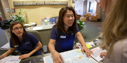 student staff helps a visitor at the infodesk