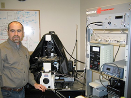 Guy Kennedy standing next to machines