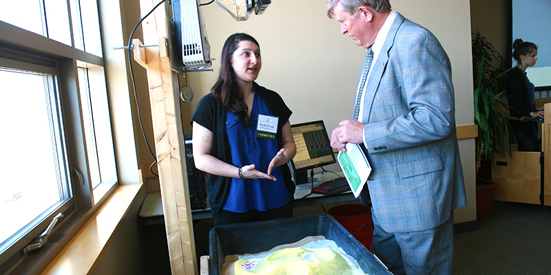 Rachel Seigel demonstrates Automated Reality Sandbox to Vice President for Research Richard Galbraith.