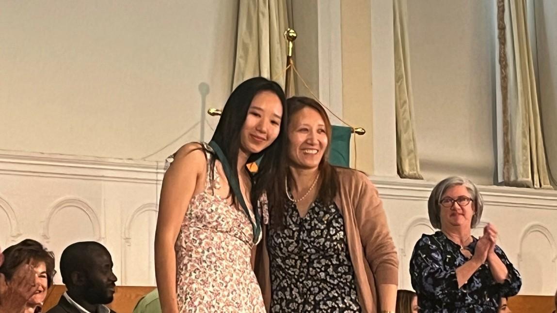 Nursing graduate Jaza Amchok '23 (left) poses with her mother after receiving her nursing pin.
