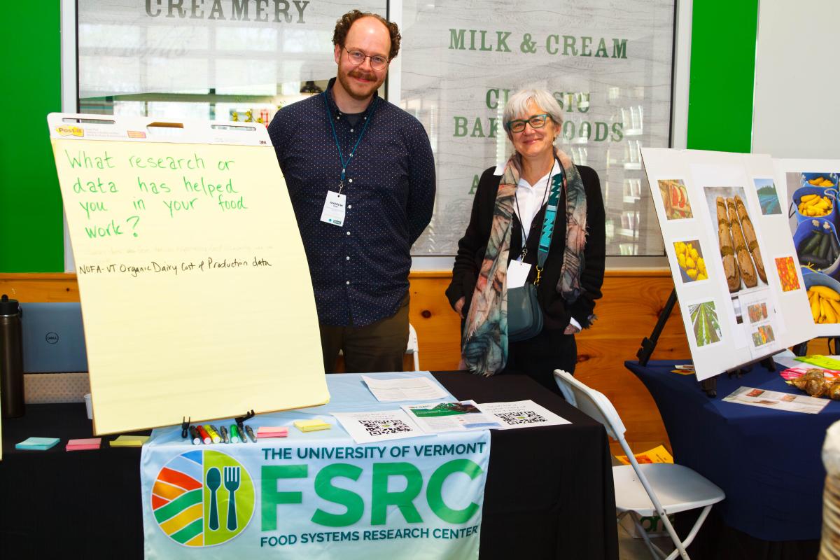 Polly Ericksen and Andrew may at their booth at the FINE conference.