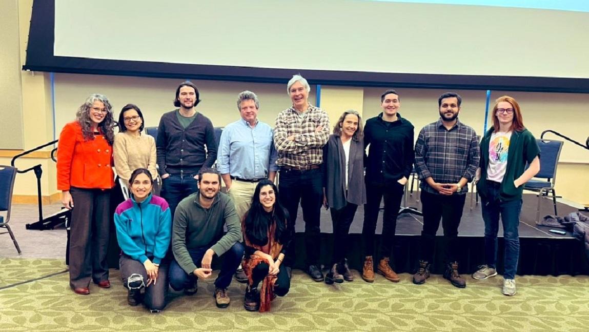 A group of faculty and event organizers posed together in the Davis Center at UVM at the Rethinking Economics event