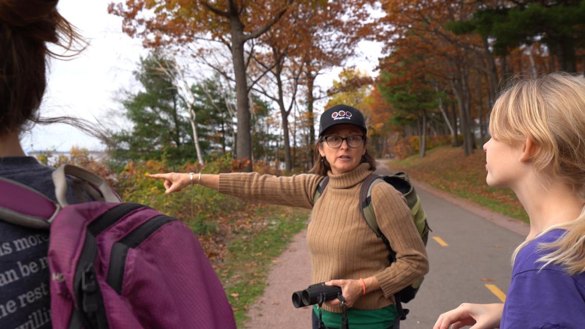 Trish O'Kane gestures to her birding class.