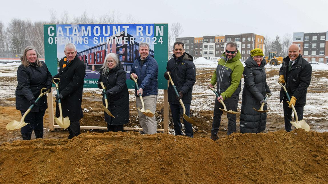 UVM officials pose with ceremonial shovels in front of the future site of Catamount Run