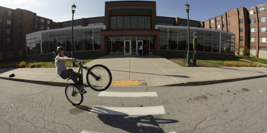 biking in front of Harris/Millis