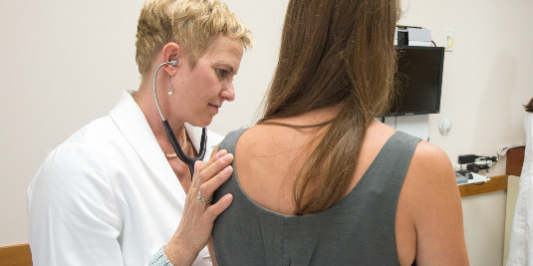 NP listening to patient's lung sounds.