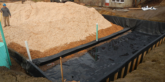 Construction of a construction worker standing in a partially completed water treatment facility