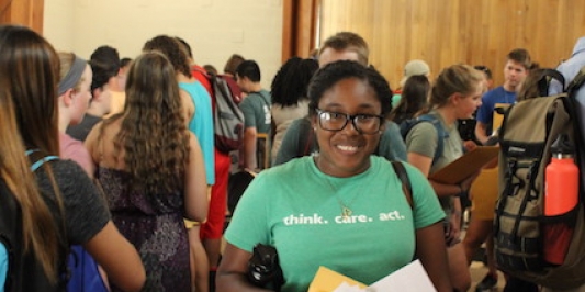 Smiling student at information fair in the Gathering Hall