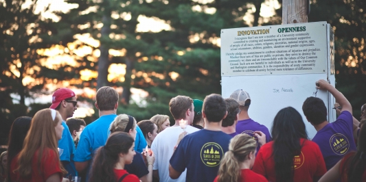 Students Sign our Common Ground at Twilight Induction Students signing common ground boards at twilight induction
