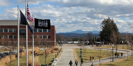 Black Lives Matter, along with US and Vermont, flag flies in front of the Davis Center