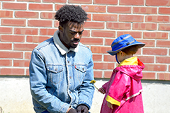 Male black student with child at UVM Campus Childrens School
