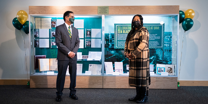 President Suresh Garimella and Vice President Wanda Heading-Grant stand in front of Celebrating Diverse Voices display case, distanced and masked