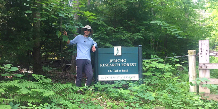 Jack Goldman stands next to Jericho Research Forest entrance sign