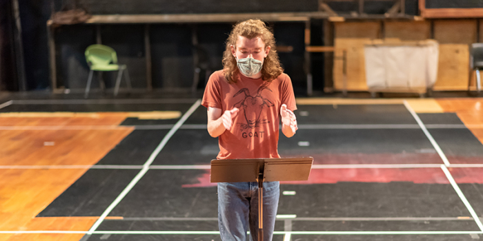 Owen Webster '22 debates at a podium