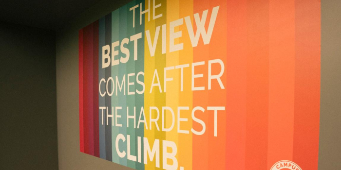 Rainbow colored sign reading "The Best View Comes After the Hardest Climb"