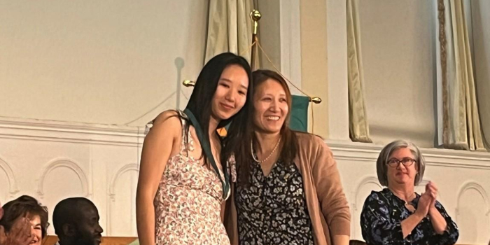 Nursing graduate Jaza Amchok '23 (left) poses with her mother after receiving her nursing pin.