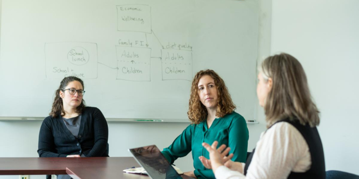 Researchers Ashley McCarthy and Farryl Bertmann discuss their research on COVID and food security as another researcher looks on