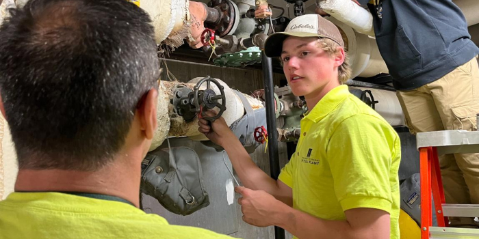 maintenance worker adjusting a valve