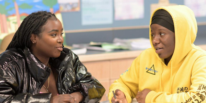 Franky Bahati works with Winooski High School student