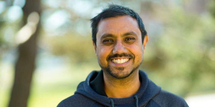 Pablo Bose standing in front of some trees. 