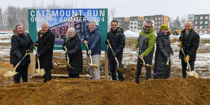 UVM officials pose with ceremonial shovels in front of the future site of Catamount Run