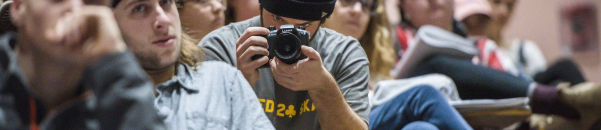 A student records an event in a lecture hall