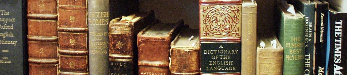 A row of old books including a dictionary of the english language
