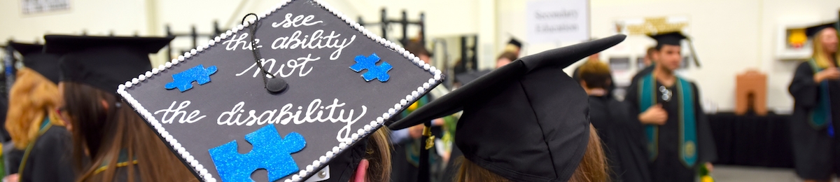 Student mortarboard at graduation reading "see the ability not disability".