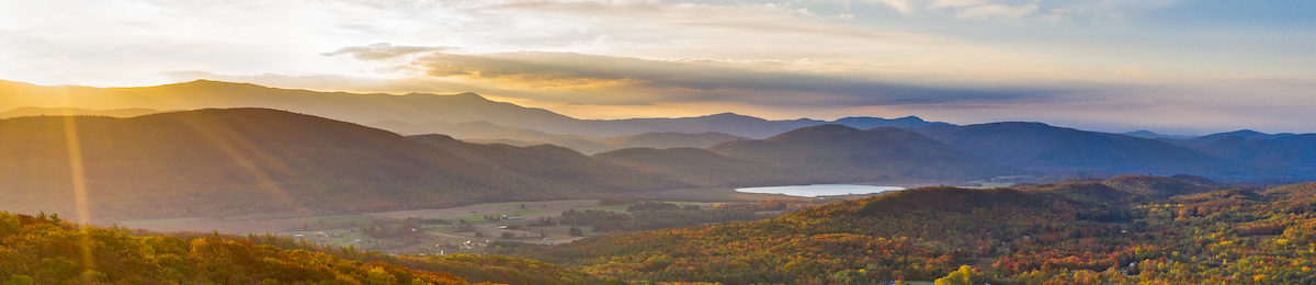 Landscape scene of a sunrise over the mountains from Monkton Vermont.