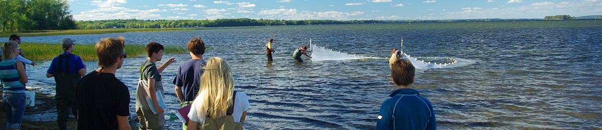 Students seine netting in lake.