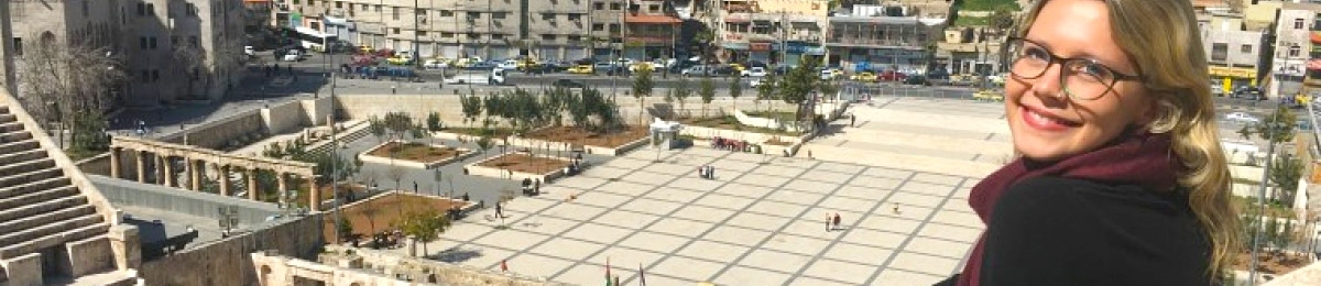 A student looks down upon an historic city square