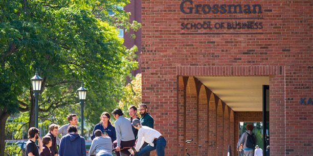 Students and faculty meet outside Kalkin Hall at the Grossman School of Business.