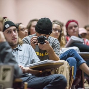 A student records an event in a lecture hall