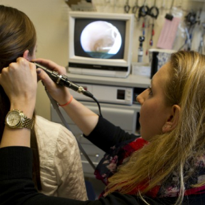 graduate students use otoscope in Luse Center