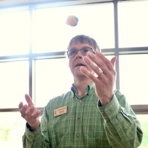 Staff Council Administrator Alan Shashok learning to juggle at the 2019 Annual Retreat.
