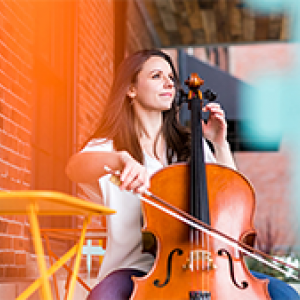 Cello Professor Emily Taubl seated at an outdoor cafe setting