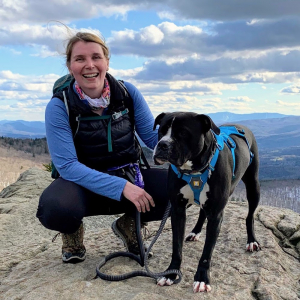 Molly Rolfe and her dog on a Vermont mountain summit