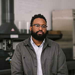 Zora Murff portrait type image with  glass and equipment in the background