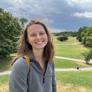 Catherine with a tree-lined campus in the background