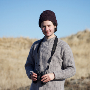 Lee in the field with binoculars