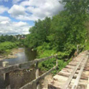 railroad bridge running over a river