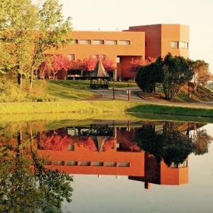 brick building overlooking a pond