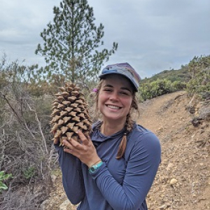 Erica holding a pinecone.