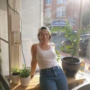 Regina Visconti on a window sill with plants