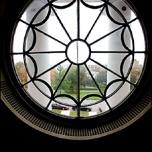 view of campus through wrought iron scalloped, round window