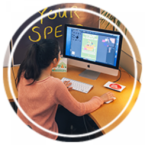 a student working at a desktop with illustrator open