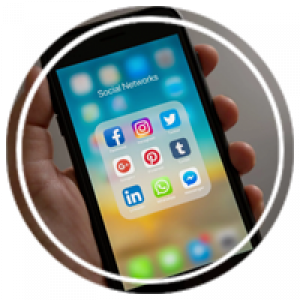 a hand holding a phone open to social media apps